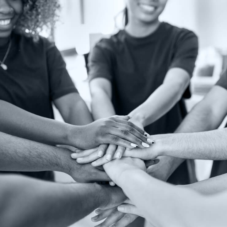 Group of people stacking hands