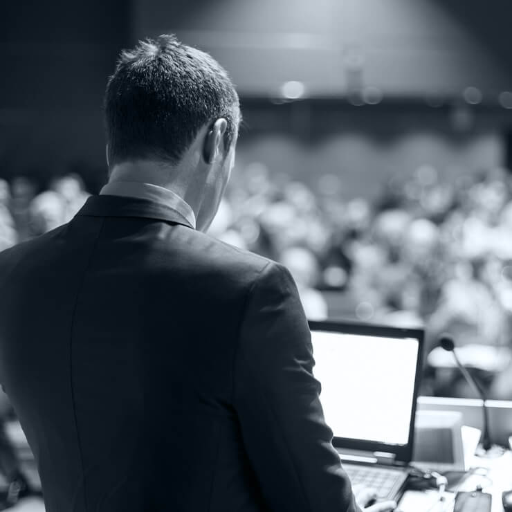 Man at podium with laptop